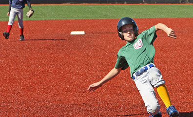 woodside sports team baseball game. player sliding onto base