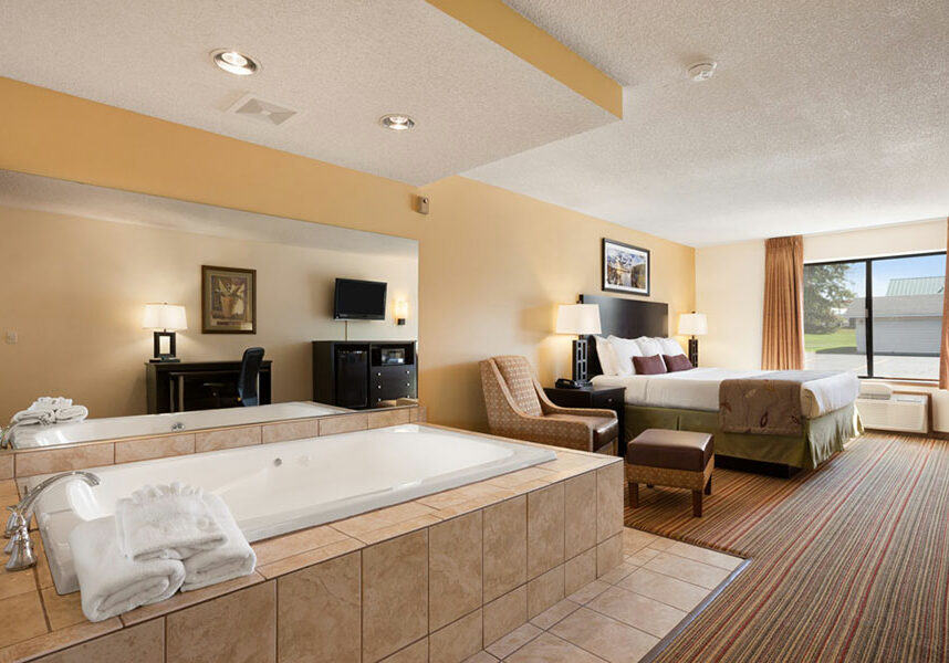 suite with king bed and jucuzzi tub at Ramada by Wyndham Wisconsin Dells
